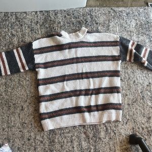 A white and green brown knitted sweater